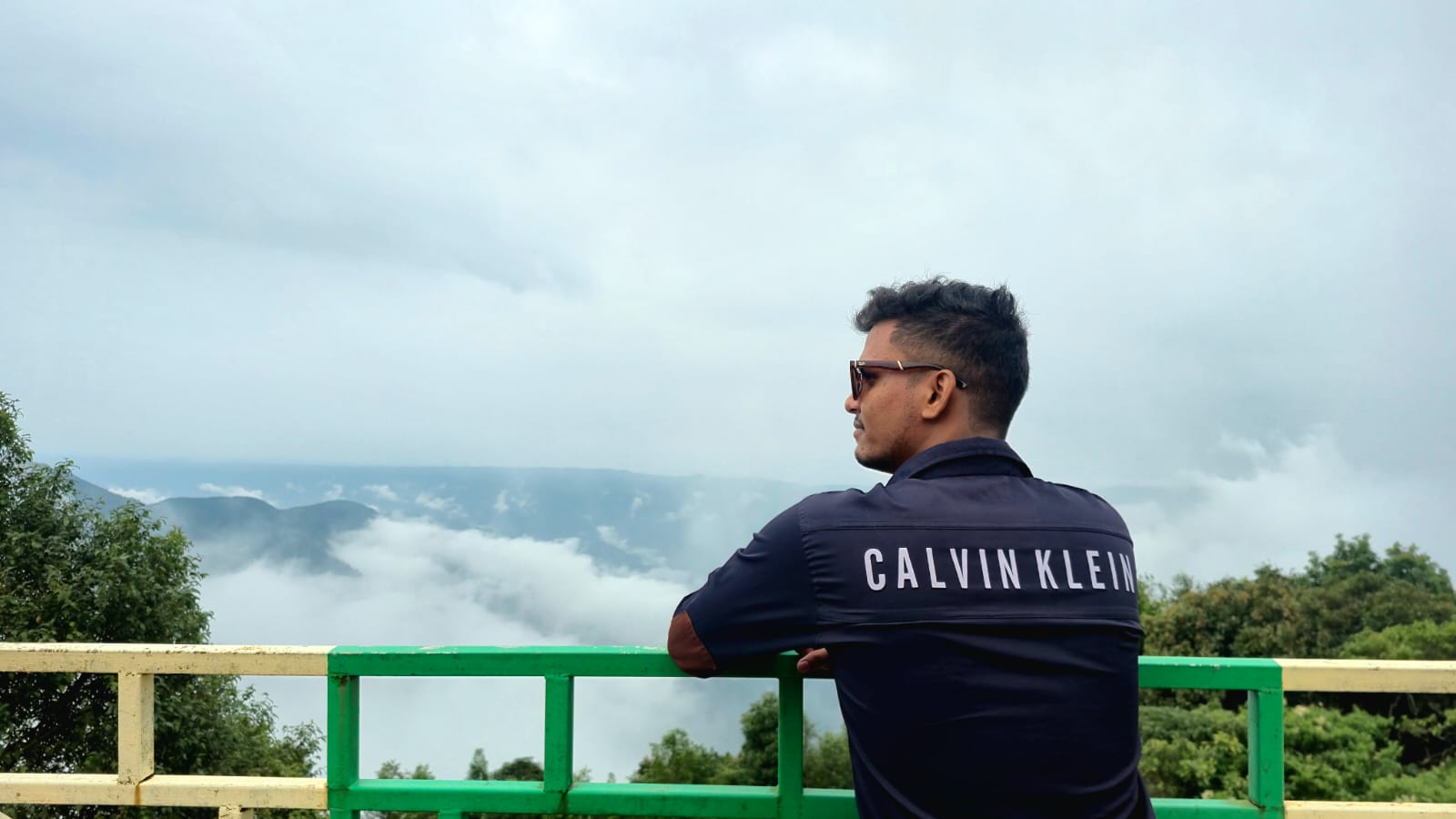 Sameer Khan standing against a mountain landscape
